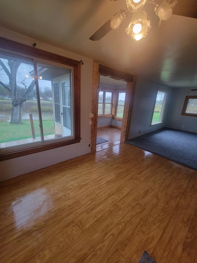 unfurnished room featuring a chandelier and wood-type flooring