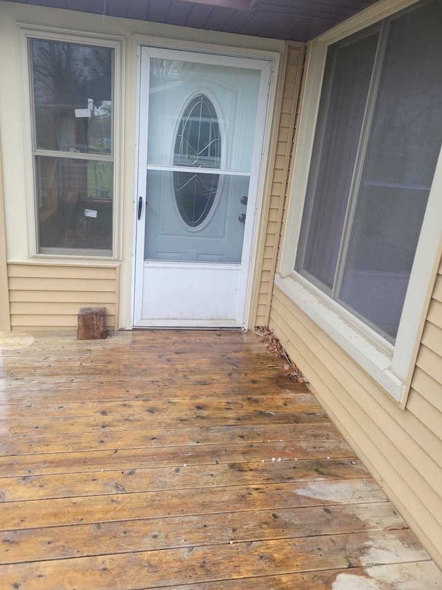 view of exterior entry with a wooden deck