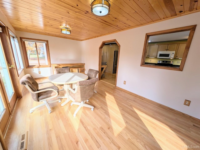 dining area with light wood-type flooring and wooden ceiling