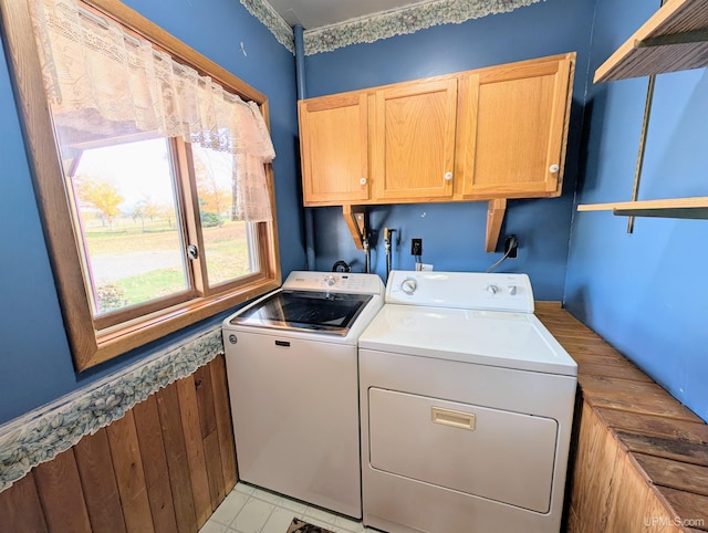 laundry room featuring washing machine and dryer and cabinets