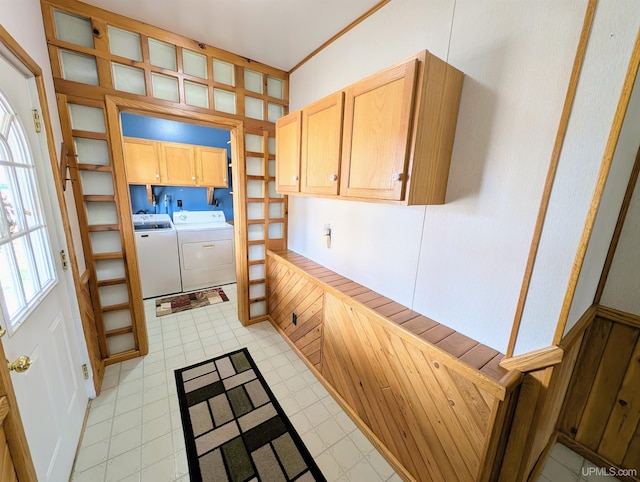 kitchen with washing machine and dryer, light floors, light brown cabinetry, and glass insert cabinets