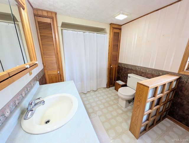 bathroom featuring a closet, tile patterned floors, toilet, and vanity