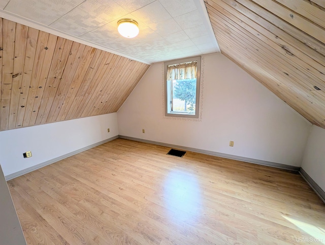 additional living space featuring light hardwood / wood-style flooring and vaulted ceiling