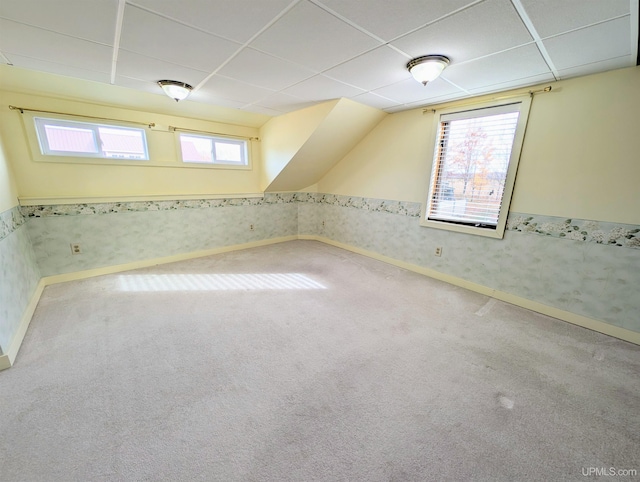 additional living space featuring carpet and baseboards