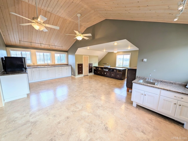 kitchen featuring wood ceiling, refrigerator, a sink, ceiling fan, and white cabinets