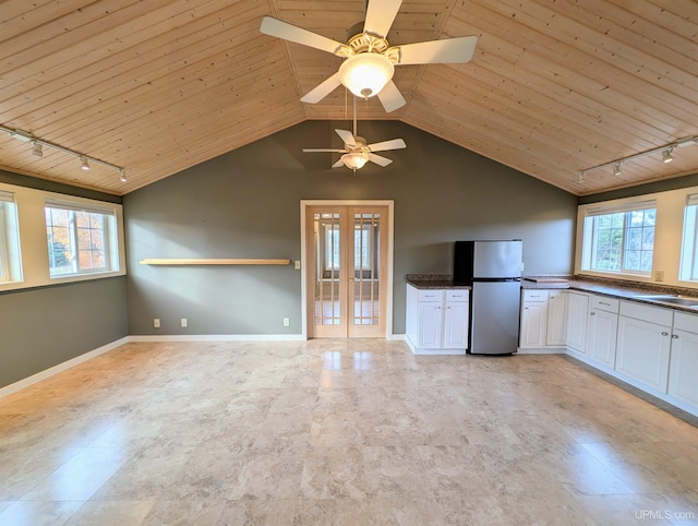 kitchen with track lighting, white cabinets, wood ceiling, and stainless steel refrigerator