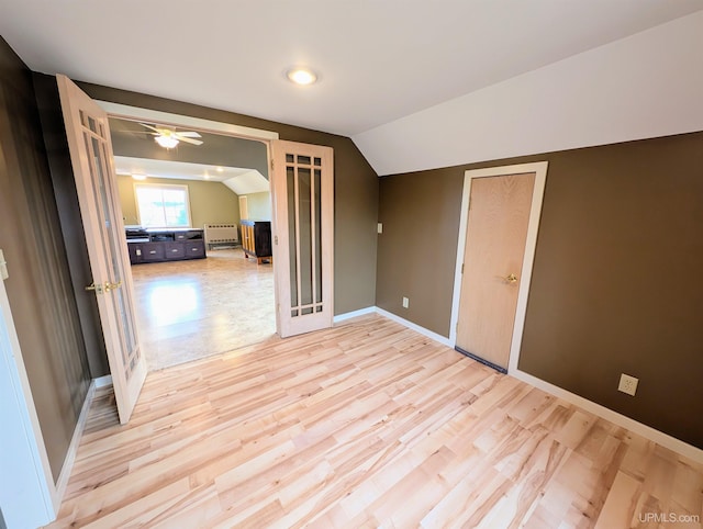 bonus room featuring light hardwood / wood-style floors, vaulted ceiling, and ceiling fan