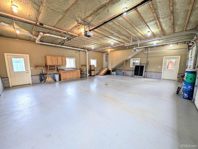 garage featuring a garage door opener and sink