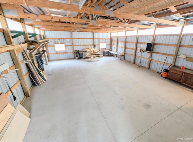 misc room with concrete floors and a garage