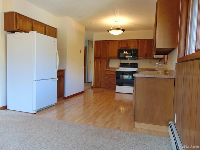 kitchen featuring white appliances, light hardwood / wood-style flooring, and baseboard heating