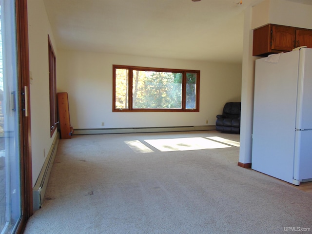 unfurnished living room with baseboard heating and light carpet