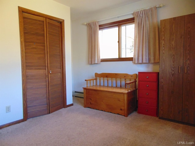 bedroom with light carpet, a closet, and a baseboard radiator