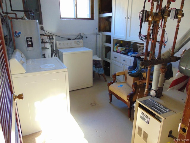 washroom with electric water heater and washer and clothes dryer