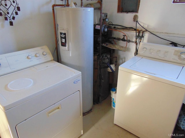 washroom with washing machine and dryer and water heater