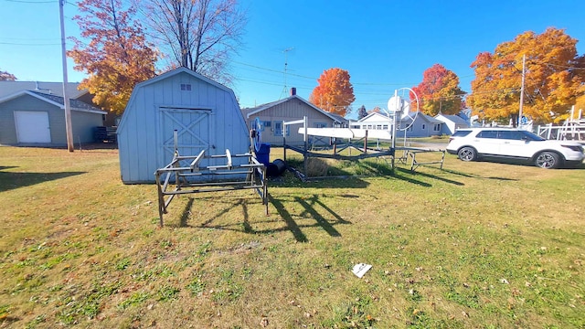 view of yard featuring a storage shed and a garage