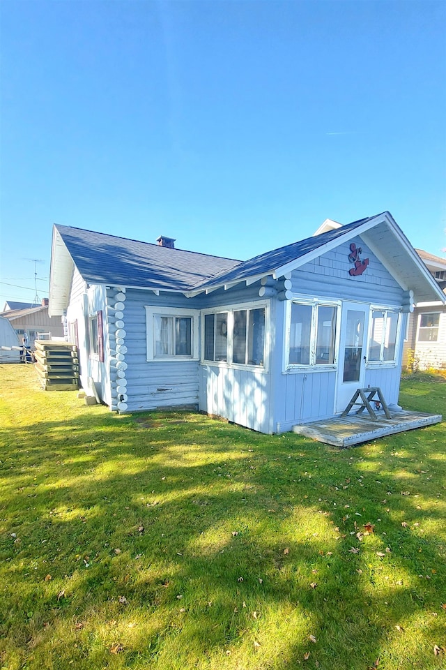 back of property featuring a lawn