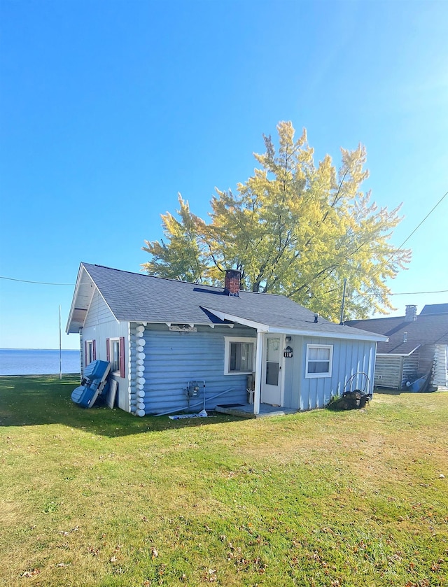 rear view of property with a lawn