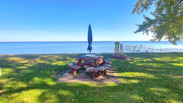 view of yard featuring a water view and a boat dock