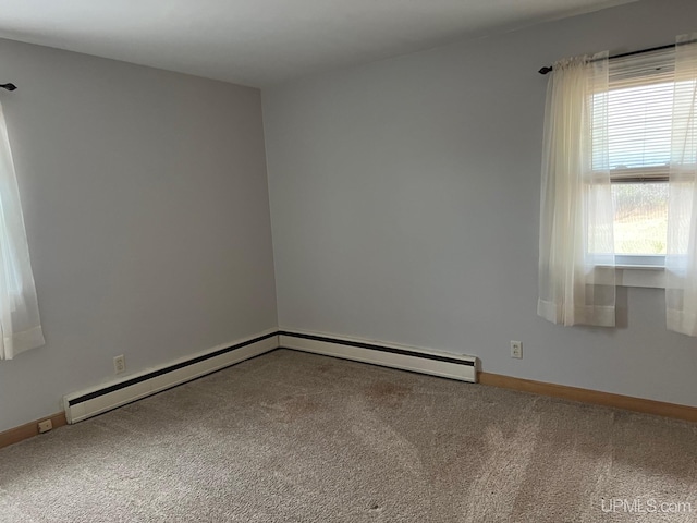 unfurnished room with a baseboard radiator and carpet floors