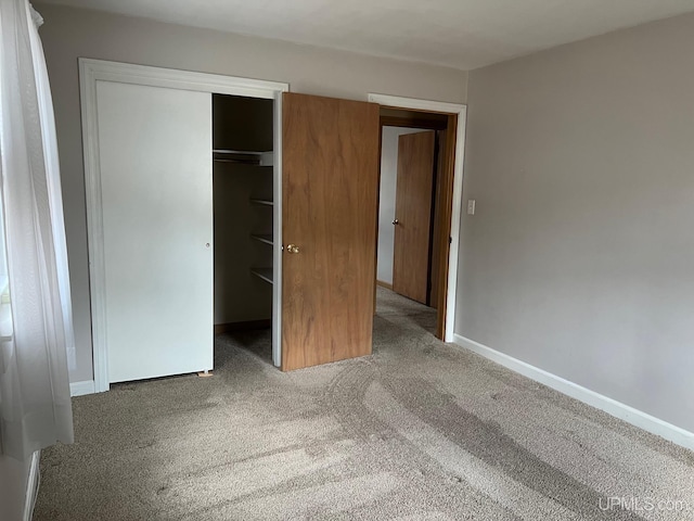 unfurnished bedroom featuring carpet floors and a closet