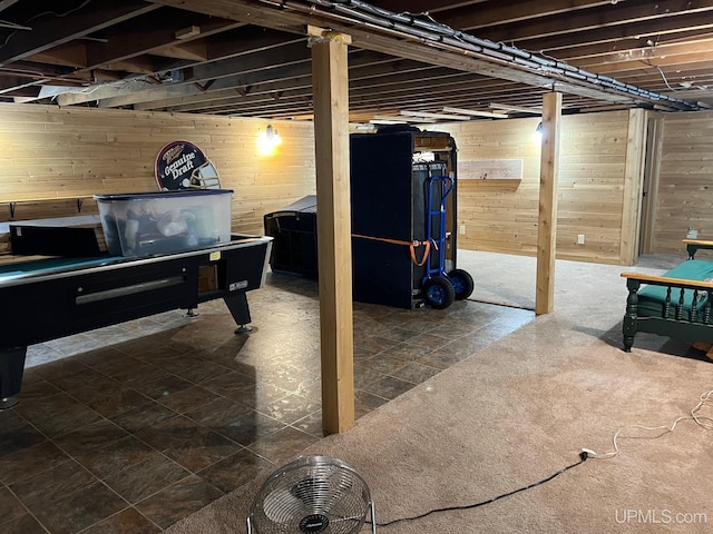 basement featuring wooden walls