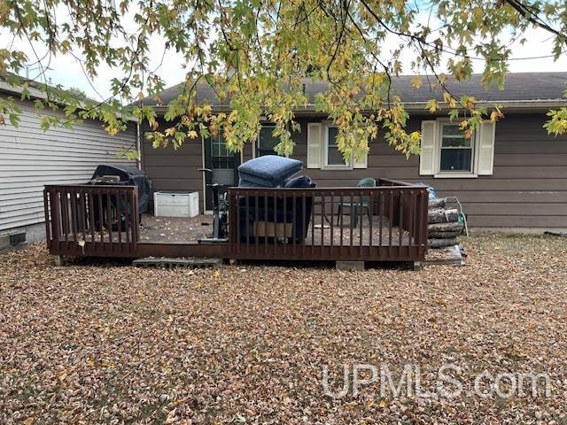 wooden terrace featuring grilling area