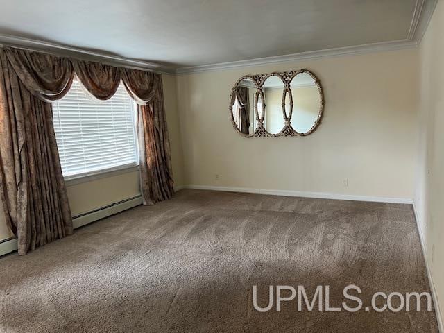 carpeted spare room featuring baseboard heating and crown molding