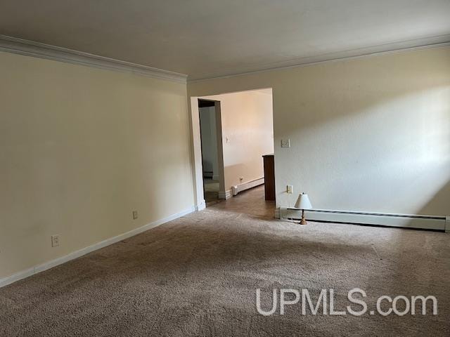 empty room featuring crown molding, a baseboard radiator, and dark colored carpet