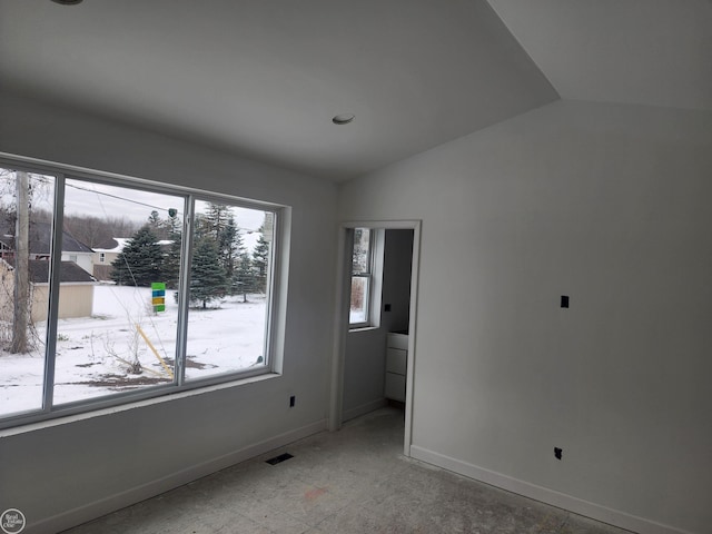 empty room featuring vaulted ceiling