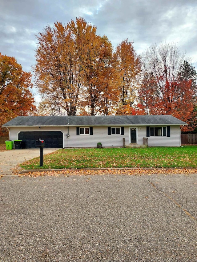 ranch-style home with a front yard and a garage