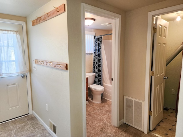 bathroom with shower / bath combination with curtain and toilet