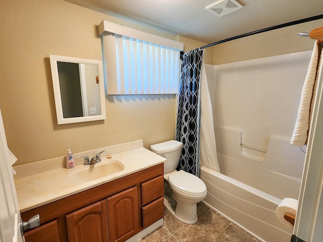 full bathroom featuring a textured ceiling, toilet, shower / bath combo, vanity, and tile patterned flooring