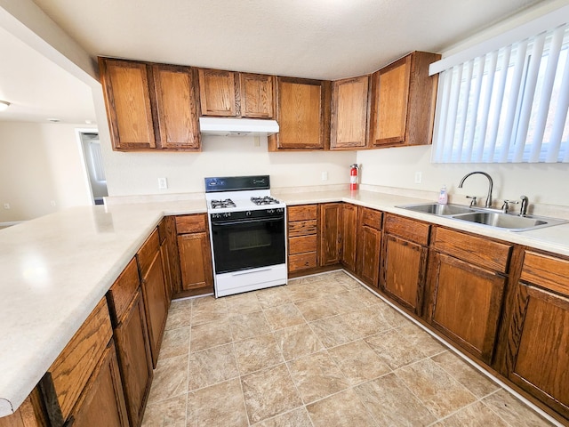 kitchen featuring sink and white gas range oven