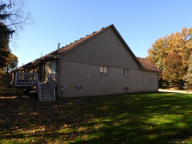 view of side of home featuring a yard