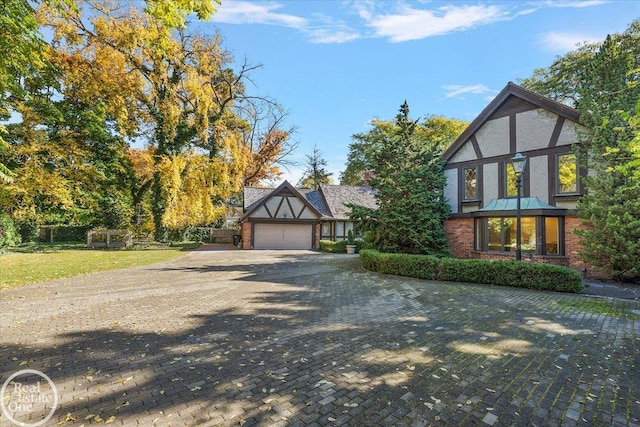 tudor-style house featuring a garage