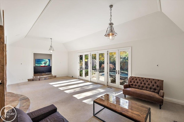 carpeted living room with french doors and vaulted ceiling