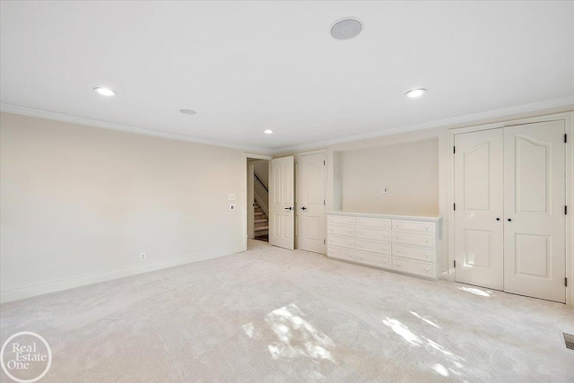 unfurnished bedroom with light carpet and crown molding