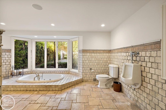 bathroom featuring toilet and tiled bath