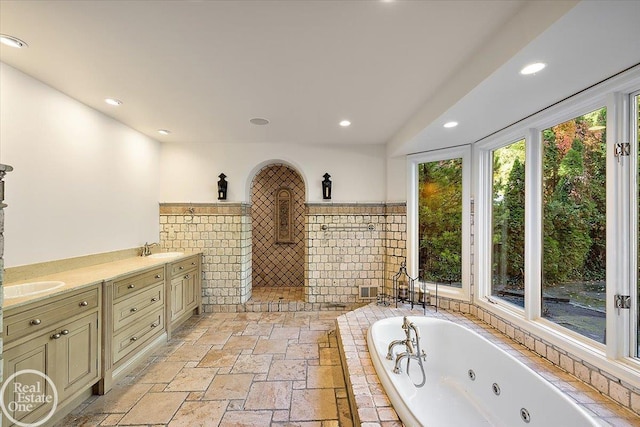 bathroom featuring vanity and shower with separate bathtub