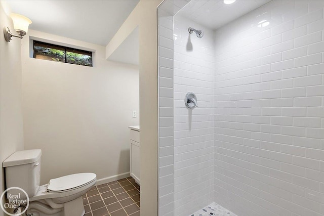 bathroom featuring toilet, vanity, a shower, and tile patterned floors