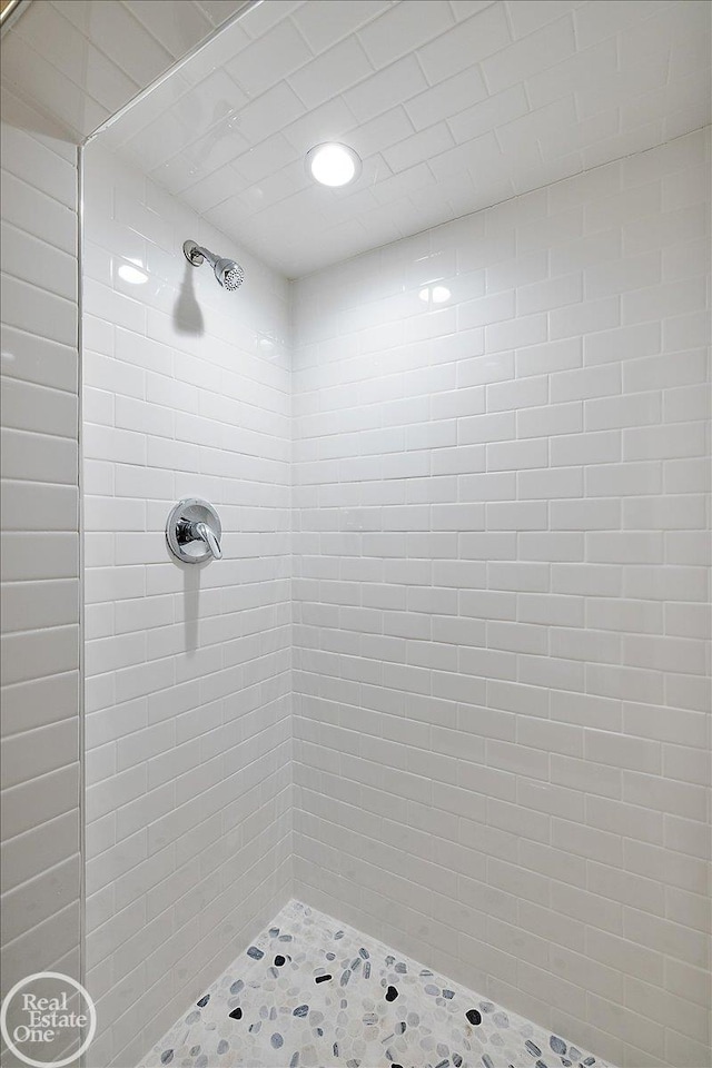 bathroom with tiled shower