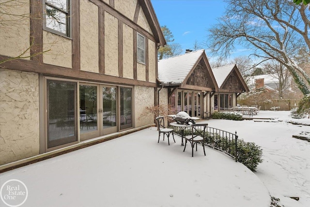 view of snow covered back of property