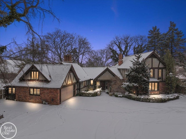 english style home with a garage