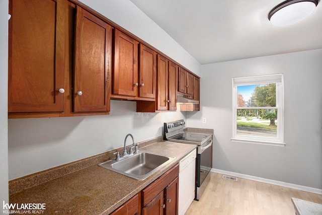 kitchen with white dishwasher, sink, stainless steel electric stove, and light wood-type flooring