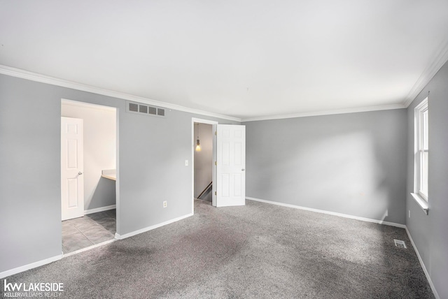 unfurnished room with ornamental molding and light colored carpet