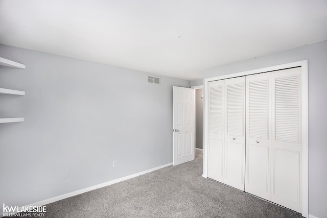 unfurnished bedroom featuring carpet floors and a closet