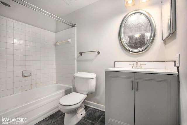 full bathroom featuring toilet, tiled shower / bath combo, vanity, and tile patterned flooring