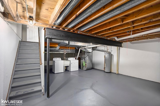 basement featuring water heater, sink, and washer and dryer