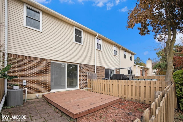 back of property featuring a wooden deck and central AC unit