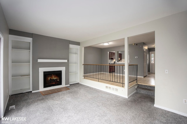 unfurnished living room featuring carpet floors